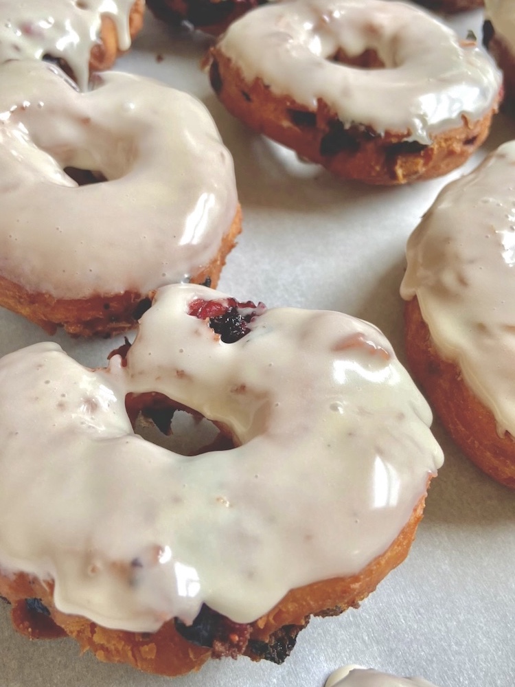 Blueberry Donuts glazed and on a baking sheet