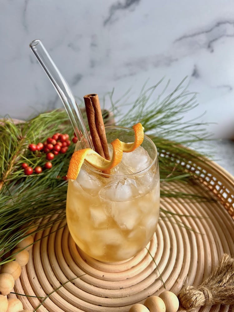 Baking Spice Winter Sangria in a stemless wine glass with glass straw