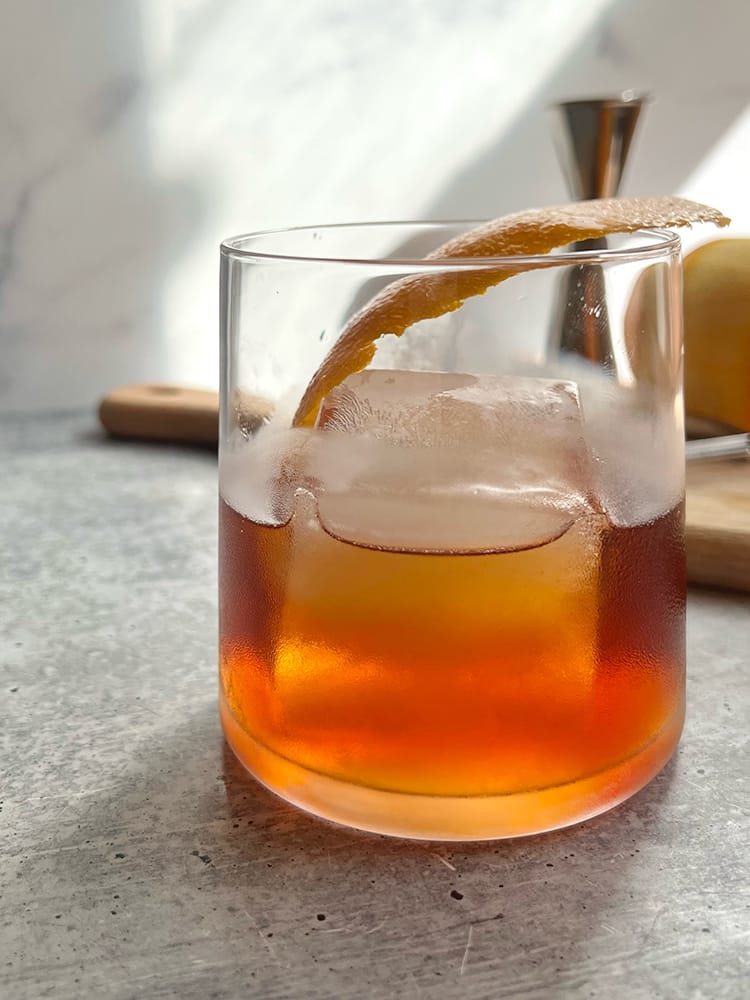 Nouveau Vieux Carre in rocks glass with large ice cube and orange peel