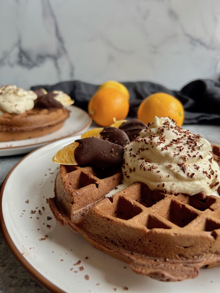 Chocolate Waffles with Orange Whipped Cream on two plates