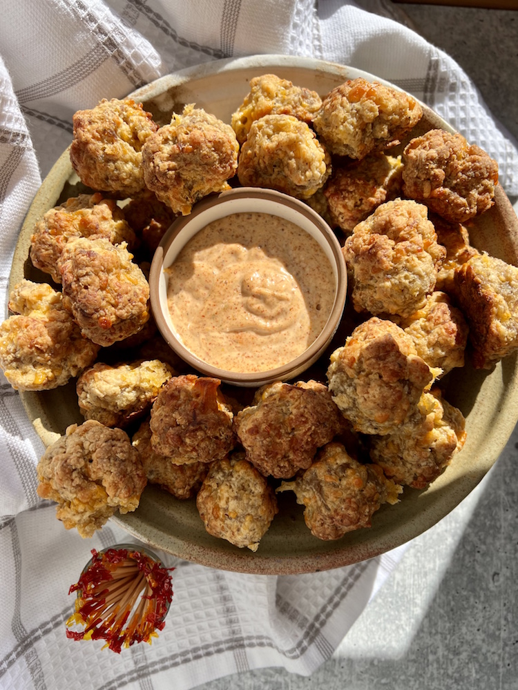 Old-Fashioned Sausage Balls in a serving basket with Cajun Dipping Sauce