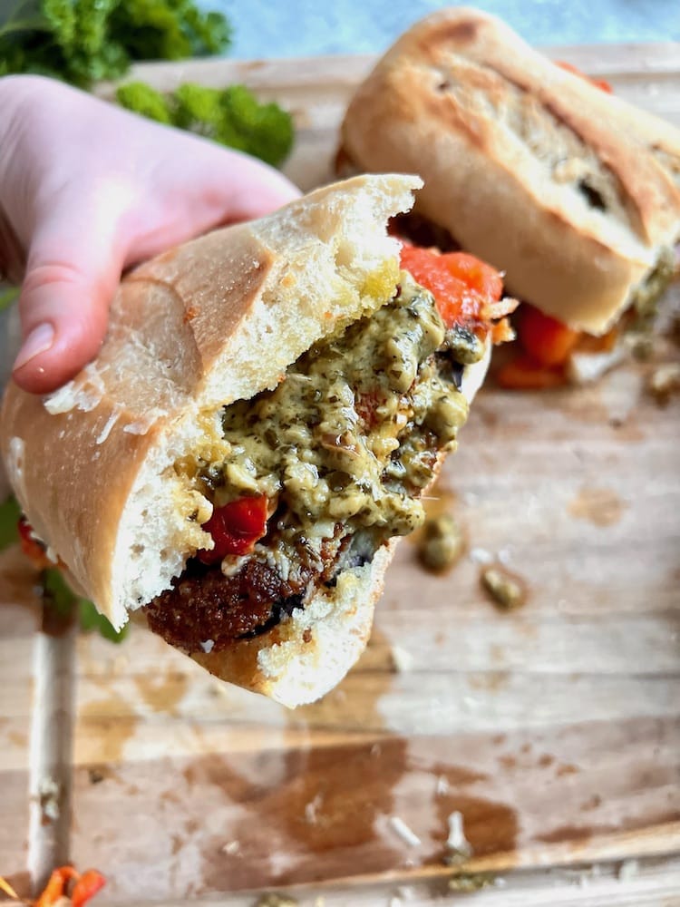 Fried Eggplant Sandwich with Pesto Cream held up to the camera