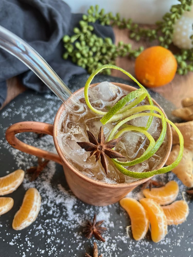 Hanoi Mule in Moscow Mule Mug next to Mandarin Orange slices