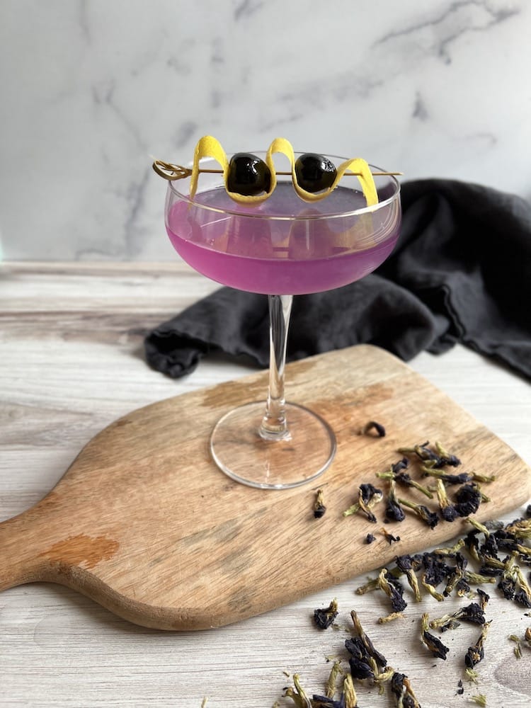 Aviation Mocktail in a coupe glass on a cutting board