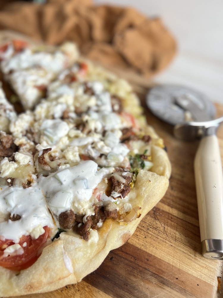 Lamb Gyro Pizza on a cutting board