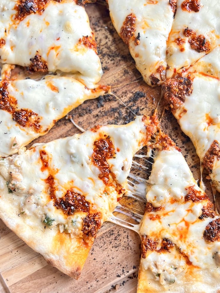 White Clam Pizza with Chili Crisp sliced up and on a cutting board
