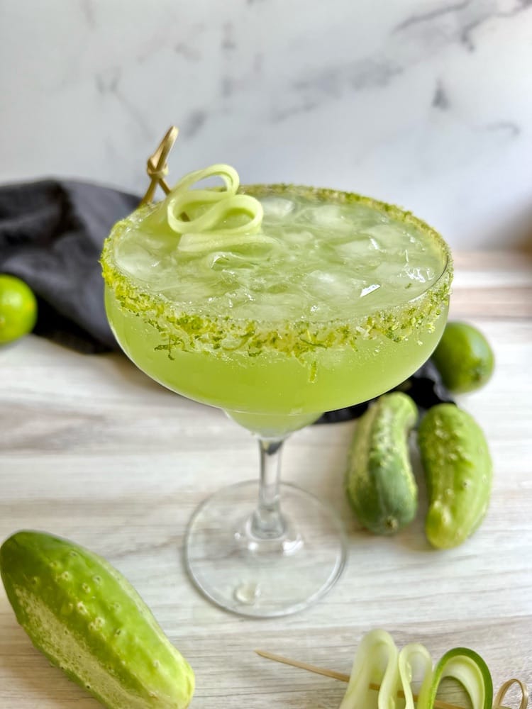 Sparkling Cucumber Margarita in a margarita glass with lime zest and salt rim