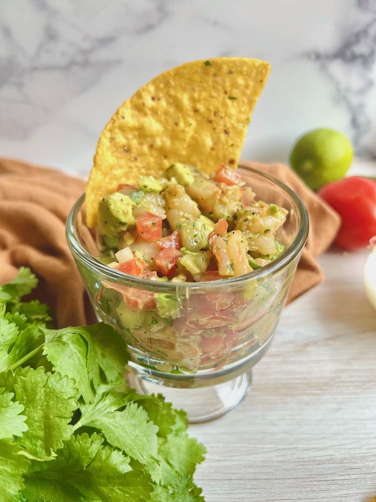 Hangry Shrimp Avocado Salad in a personal serving bowl with a tortilla chip