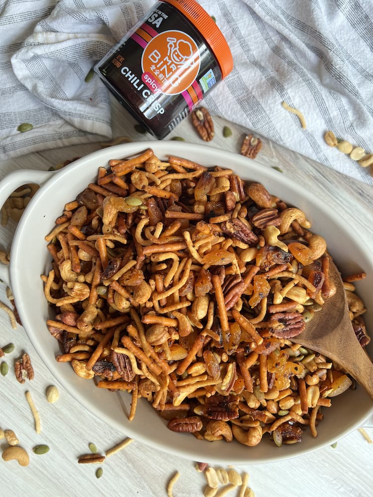 Chili Crisp Trail Mix in a serving bowl with wooden serving spoon
