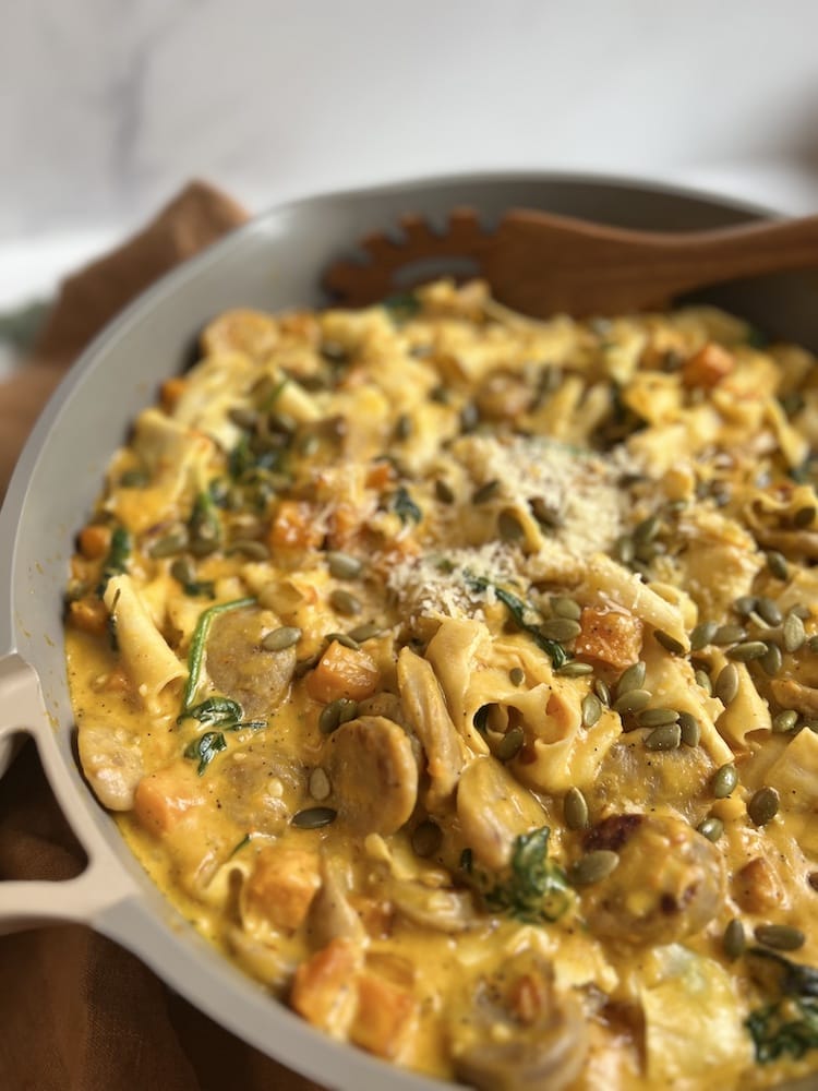 Creamy Butternut Squash Pasta in a pan with wooden spoon