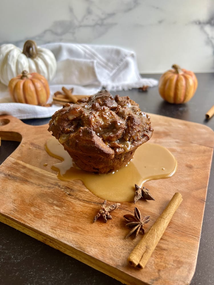 Pumpkin Espresso Bread Pudding on a wooden cutting board surrounded by cinnamon sticks and star anise