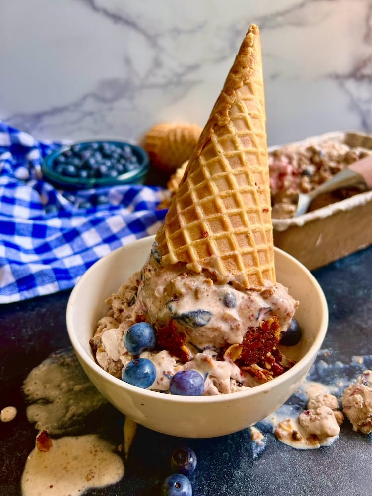 Blueberry Crisp Ice Cream in an upside down ice cream cone placed in a white bowl