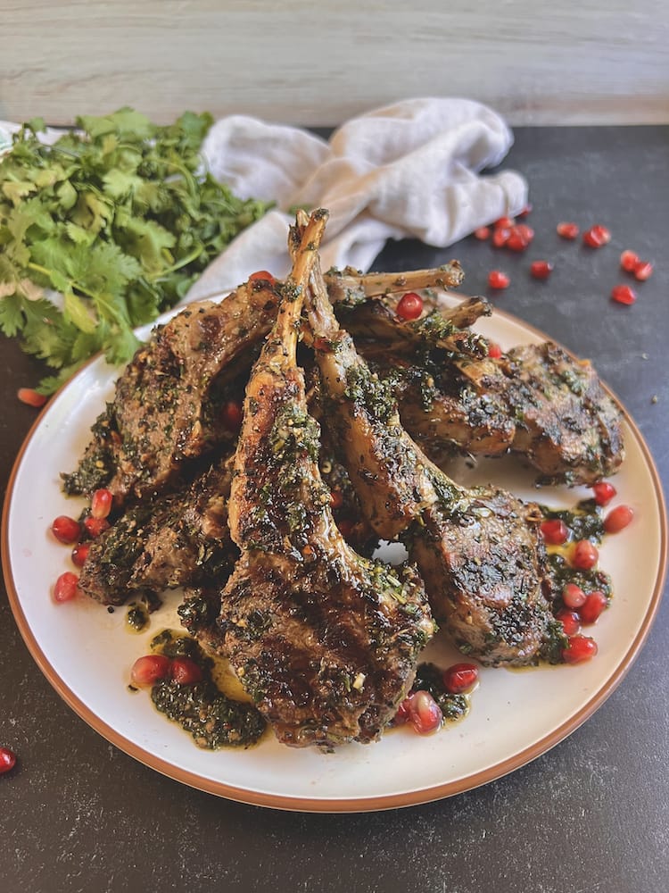 Grilled Lamb Chops with Pomegranate Chimi on a white plate