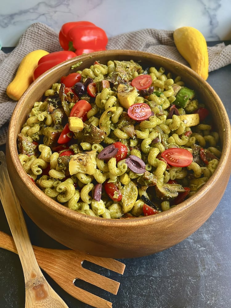 Grilled Antipasto Salad in a wooden bowl with wooden serving fork and spoon