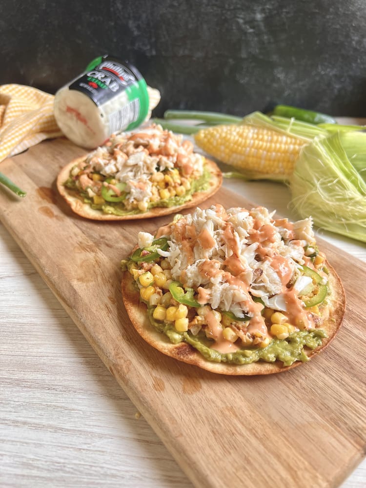 Baja Crab Tostadas on a wooden cutting board