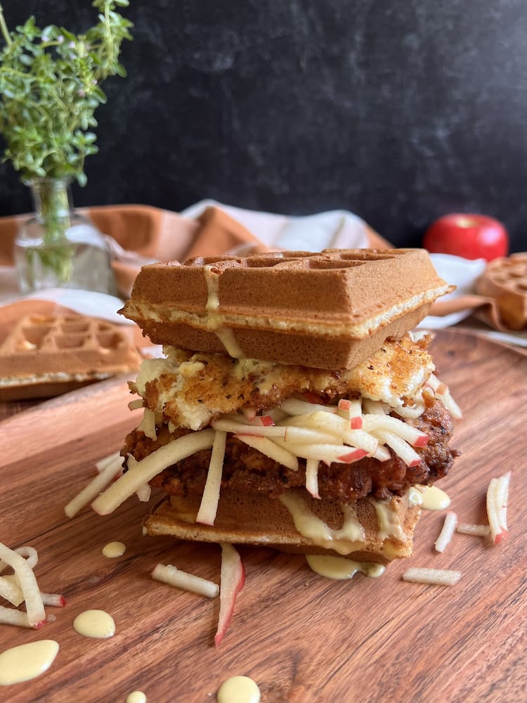 A Barn and Orchard Waffle Sandwich on a wooden cutting board