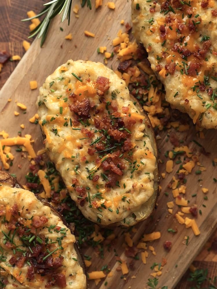 Twice Baked Potatoes on a wooden cutting board