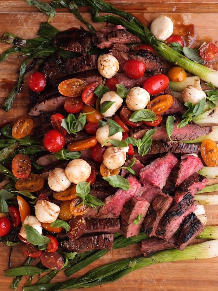 Flank Steak Caprese on a wooden cutting board