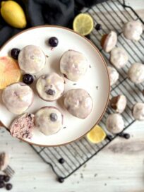 Blueberry Lavender Mini Muffins on a plate with one cut in half.
