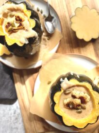 Creamy cauliflower soup inside two acorn squash bowls