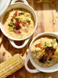 Poblano Bacon Potato Corn Chowder in two bowls next to an ear of corn